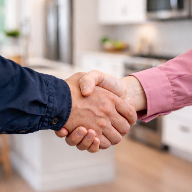 Handshake between a man and a woman in a modern renovated home