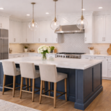 Modern kitchen with white cabinets, navy island, and quartz countertop